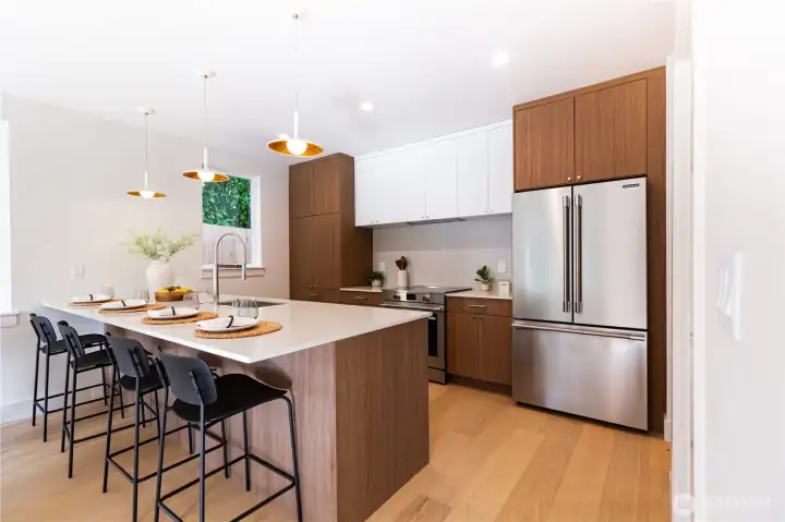 The kitchen feature a large quartz peninsula counter, Bellmont cabinetry, high-end stainless appliances with induction range and loads of storage space. The kitchen feature a large quartz peninsula counter, Bellmont cabinetry, high-end stainless appliances with induction range and loads of storage space.