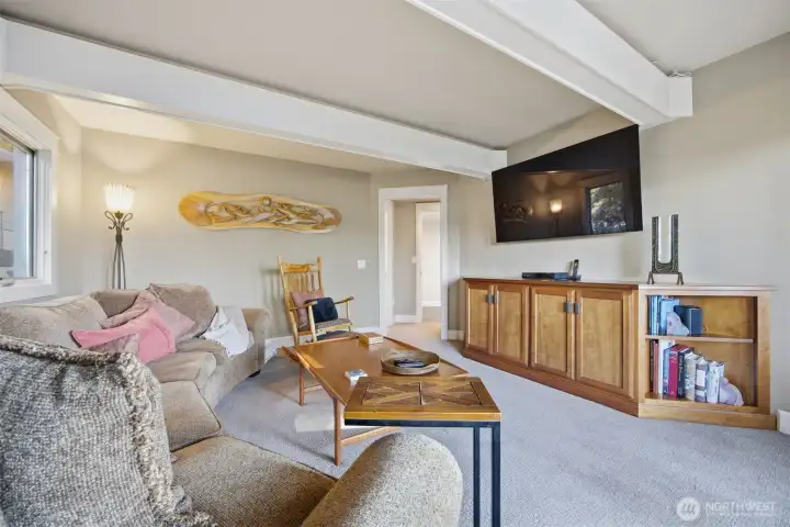 Main floor TV room. Ensuite bath means it could also work as a main floor bedroom with a view.