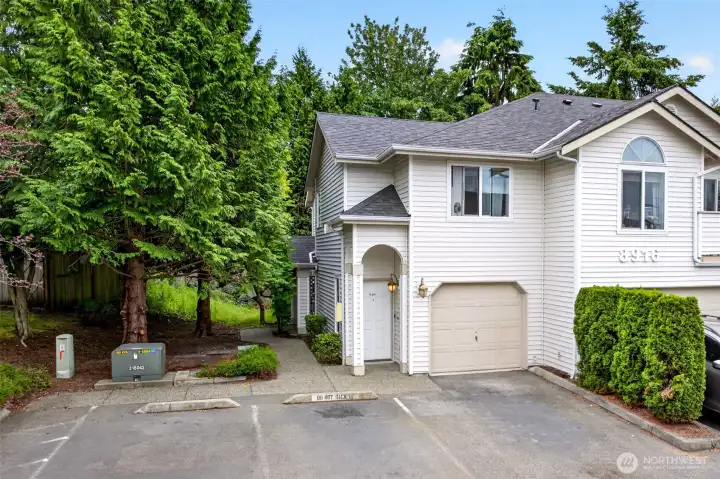 Towering evergreens frame the approach to the private entrance, giving the home a secluded, retreat-like feel just minutes from downtown Lake Stevens. The attached garage and dedicated parking add everyday convenience you'll appreciate in any season.
