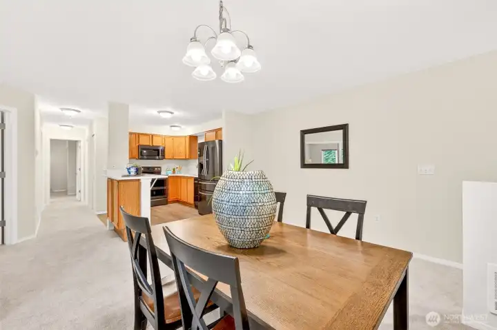The dining area opens directly toward the kitchen and hallway, keeping conversation and connection flowing throughout the home. New carpet and a smart, efficient floor plan make the most of every square foot on this single-level top floor.