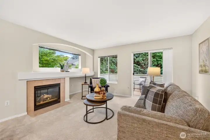 A gas fireplace and a private deck just beyond the slider make this living space a true year-round comfort zone. The wooded outlook turns morning coffee or evening downtime into a peaceful, nature-framed escape.
