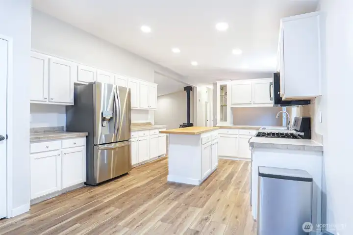 Updated cabinetry, ample counter space, and stainless steel appliances make this kitchen both practical and inviting. Updated cabinetry, ample counter space, and stainless steel appliances make this kitchen both practical and inviting.