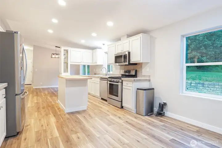 Kitchen leading into connected dining space. Kitchen leading into connected dining space.