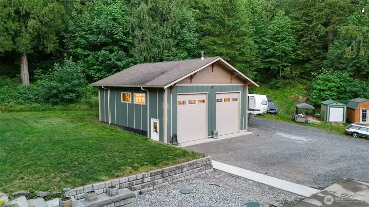 Two large garage bays offer flexibility for vehicles, recreational toys, and workshop needs. Two large garage bays offer flexibility for vehicles, recreational toys, and workshop needs.