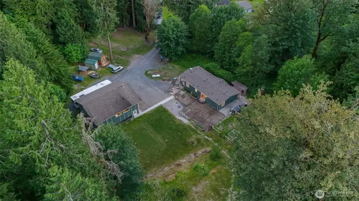 A peaceful homesite tucked into the forest with a circular drive, detached shop, and expansive wooded surroundings. A peaceful homesite tucked into the forest with a circular drive, detached shop, and expansive wooded surroundings.