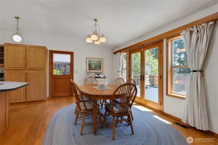 Dining area with french doors leading out to the huge, entertaining wrap around deck. Dining area with french doors leading out to the huge, entertaining wrap around deck.
