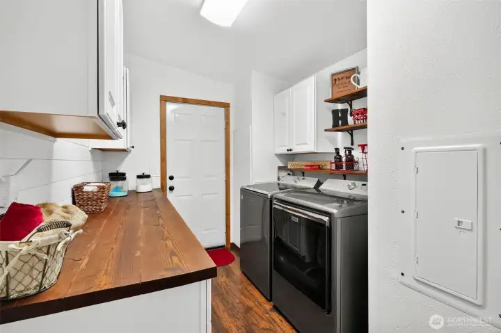 Laundry room with folding area, super storage and door to attached garage. Laundry room with folding area, super storage and door to attached garage.