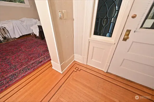 Entry with preserved details like inlaid hardwoods & leaded windows.