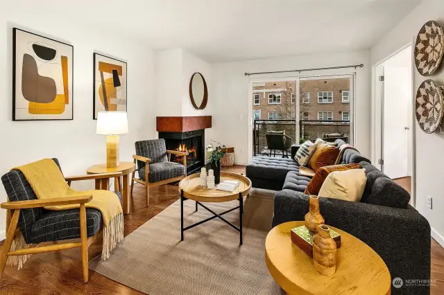 Anchored by a wood burning fireplace, the living room also has a great balcony overlooking 4th Ave W.