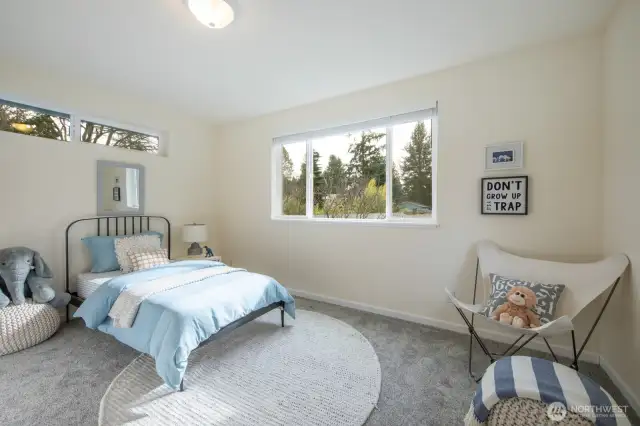 This sweet second floor bedroom has a large closet and gets light from the East, South and West.