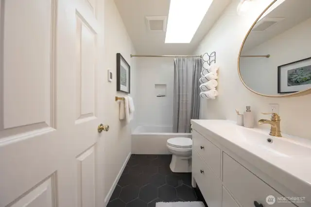 Primary suite is complete with this beautiful full bath - heated floors, deep tub, skylight. Chef's kiss!