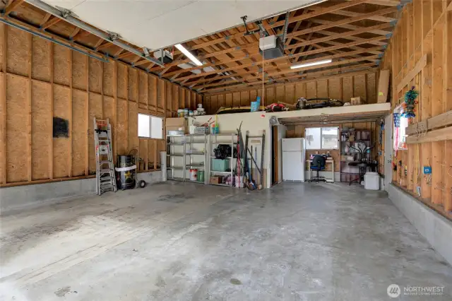 storage loft and storage room in the back of the garage