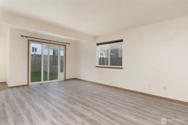 Living room leads to backyard.