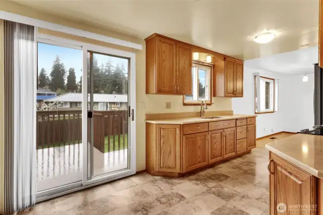 Eating area in kitchen with slider to backyard deck.