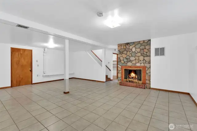 Rec room with woodburning fireplace.
