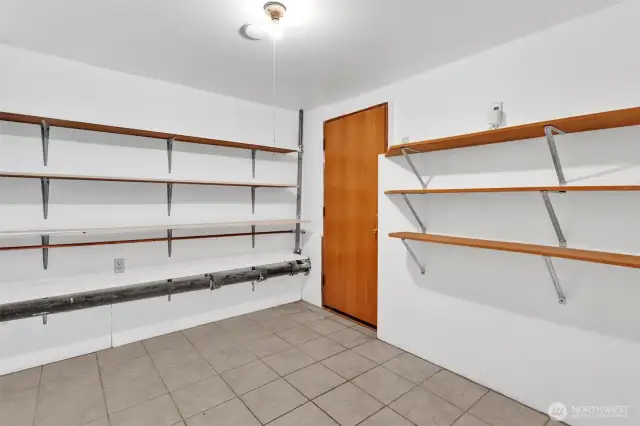 Storage room with shelving to keep you organized. Door leads to backyard and storage area under the deck.
