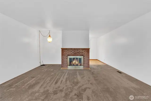 Large living room with woodburning fireplace.