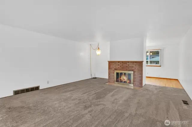 Large living room with woodburning fireplace.