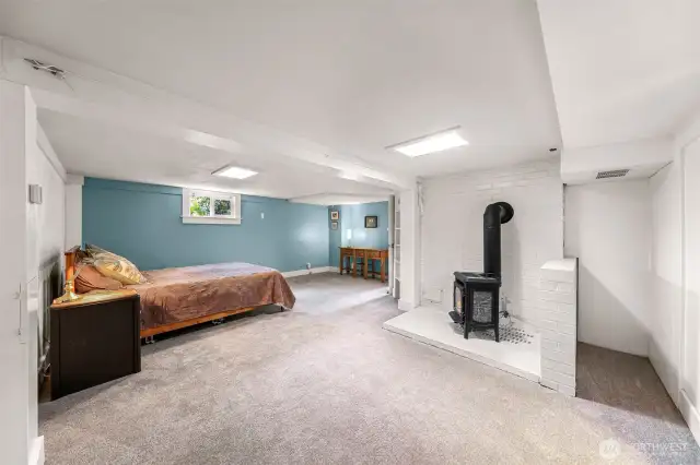 Shows bonus room with cozy gas fire stove.
