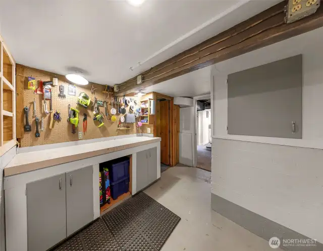 Basement workroom/shop. Additional shop space in back yard with electricity.