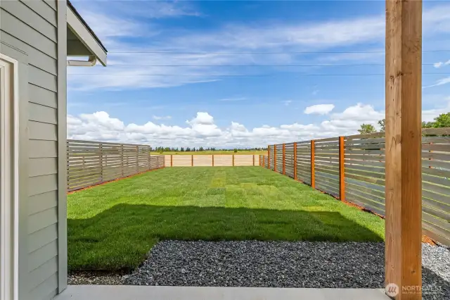 Covered patio with beautiful grass backyard