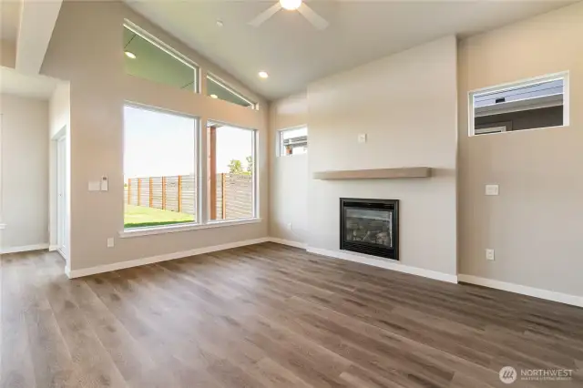 Living area has a gas fireplace and glass slider leading to backyard