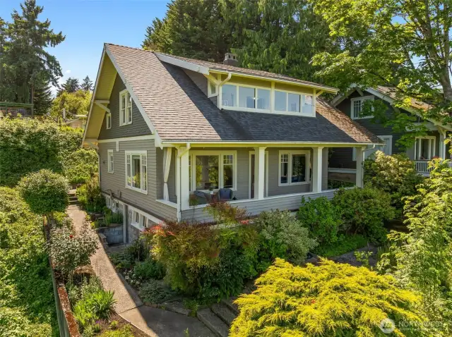 Surrounded by green space, this 1913 Craftsman bungalow has been lovingly preserved and maintained.