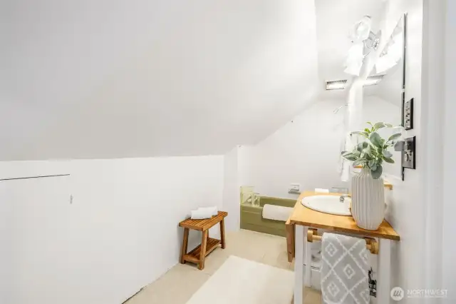 The second of two full bathrooms, this one is upstairs. Despite the sloped ceiling, the footprint is quite spacious.