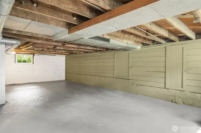The downstairs is a blank canvas of possibility. The unfinished ceilings provide a look at the bones of the home.