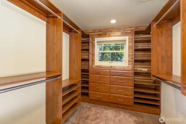 Walk in closet with built in shelving.
