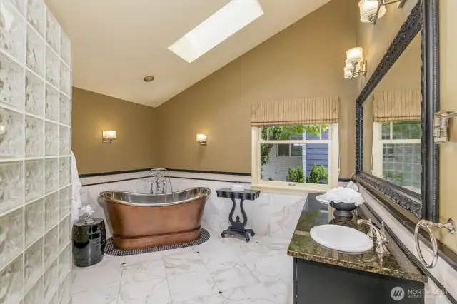Copper tub and two-headed shower in primary bathoom.  Heated floor.