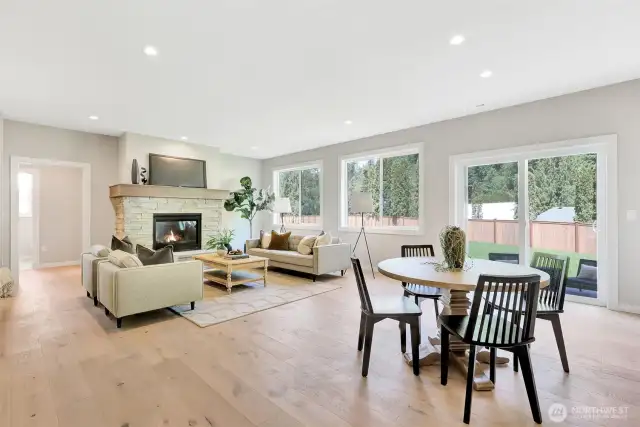 Kitchen nook to large family room with gas fireplace. Previous built Peak house. Finishes may be different.