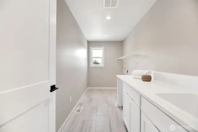 Upstairs laundry room. Previous built Peak house. Finishes may be different.