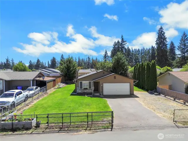 Completely fenced yard with driveway gate.