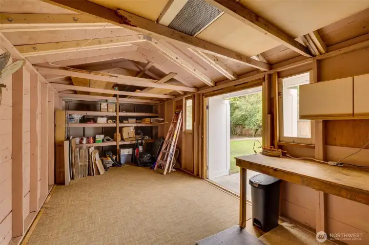 Inside the huge storage shed. It is not wired for power but could easily be done and turned into an office/she shed/man cave, use your imagination here.