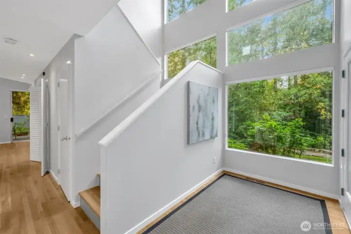 Entering the newly painted interior, one is struck by the two-story, sunny entrance. Hardwood floors flow thru out the home