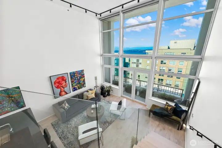 A glass-panel stair railing offers breathtaking views of the Puget Sound