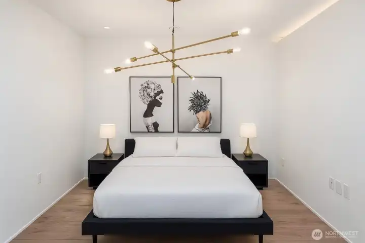 The seller currently uses the second bedroom as a dining room. To help your clients envision its potential, here is a virtual image showcasing the room with a queen bed and nightstands. You can find more information about it on the supplements.