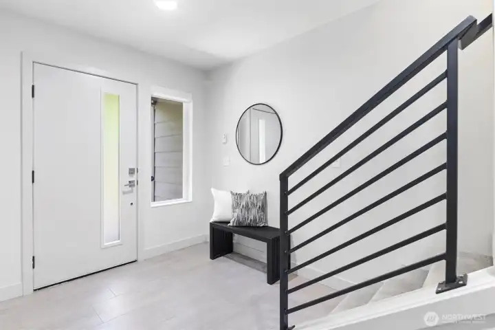 Covered entry on ground level opens to bright foyer with durable tiled floor.