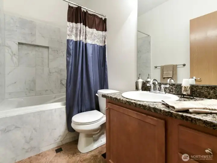 2nd Bath in hall. Jacuzzi tub. Tile enclosure. Granite counter tops backsplashes. Tile Flooring.