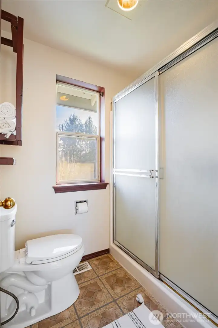 Isolated toilet and double stand-up shower in Primary.