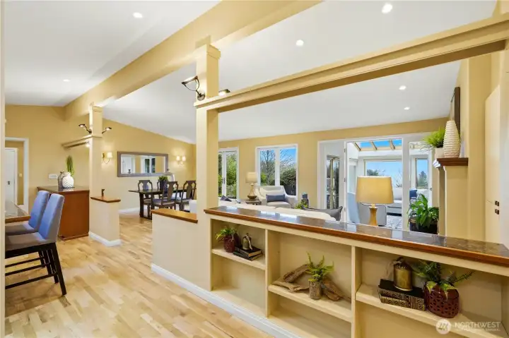 A grand entrance reveals the home's flowing layout - the open-plan dining and living areas unfold elegantly to the right, while a well-appointed kitchen awaits to the left.