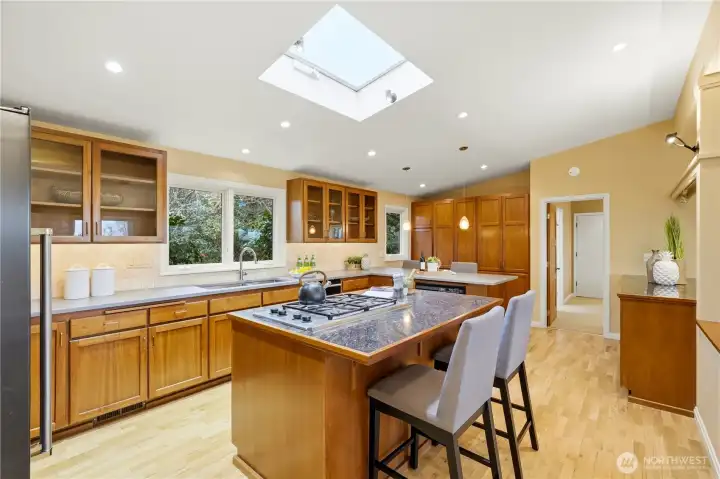 The expansive open kitchen is thoughtfully designed, offering abundant storage and multiple casual seating areas.