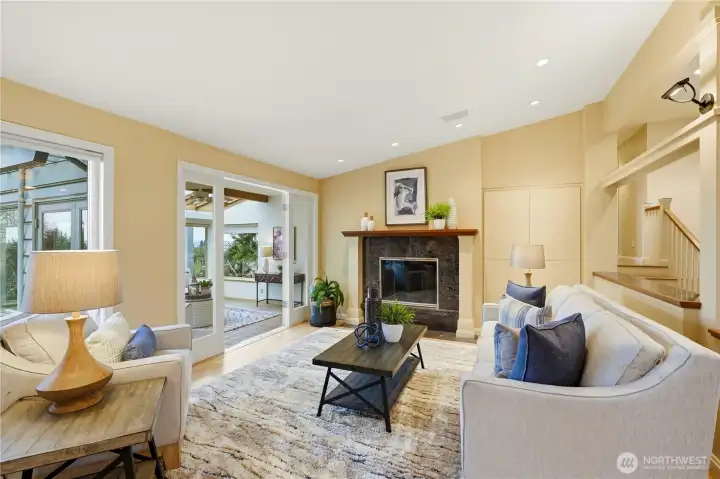 Another angle of the living area, with doors opening to the sunroom.
