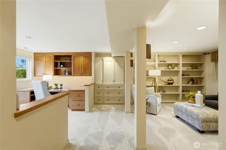 The lower level family room features two built-in work stations.