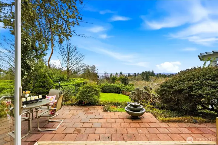 The patio overlooks a beautifully expansive yard with lovely views.