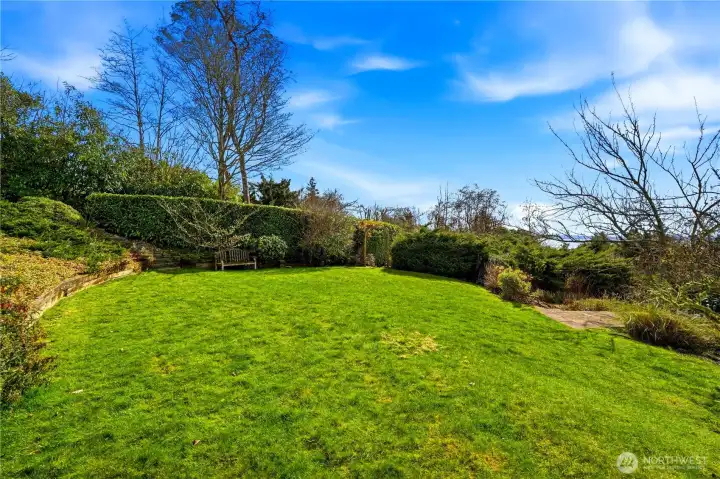 This open lawn area is located just below the deck and patio.