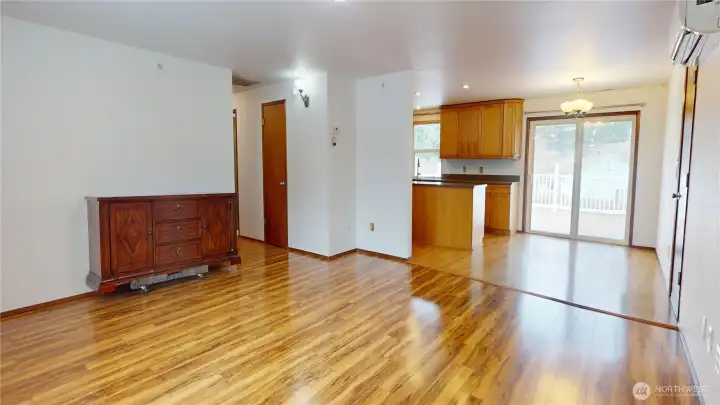 The living room is open to the dining room & kitchen