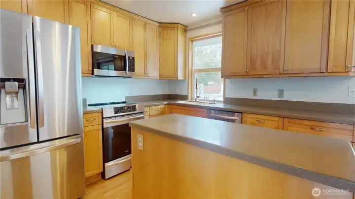 Stainless appliances can be found in this bright and open kitchen