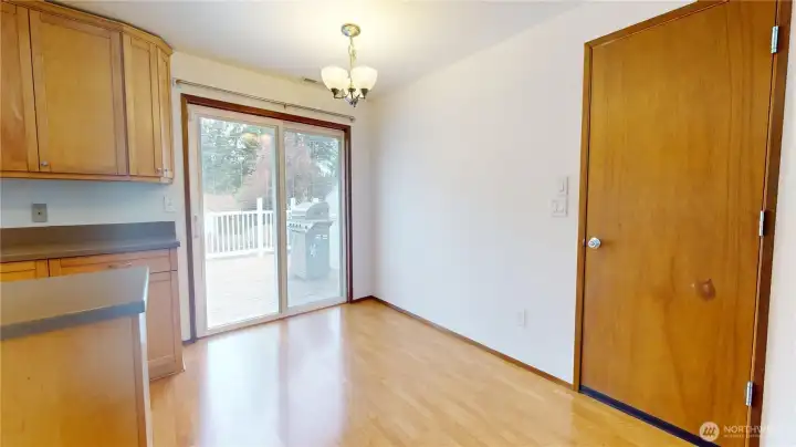 A dining room with convenient slider to access the massive back deck for seemless entertaining.